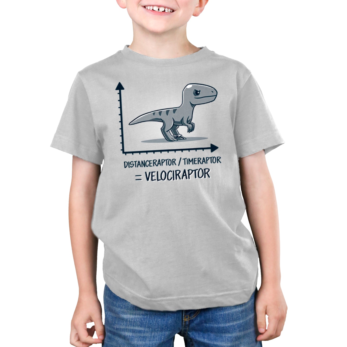 A young boy wearing a grey t-shirt with a Velociraptor design from TeeTurtle.