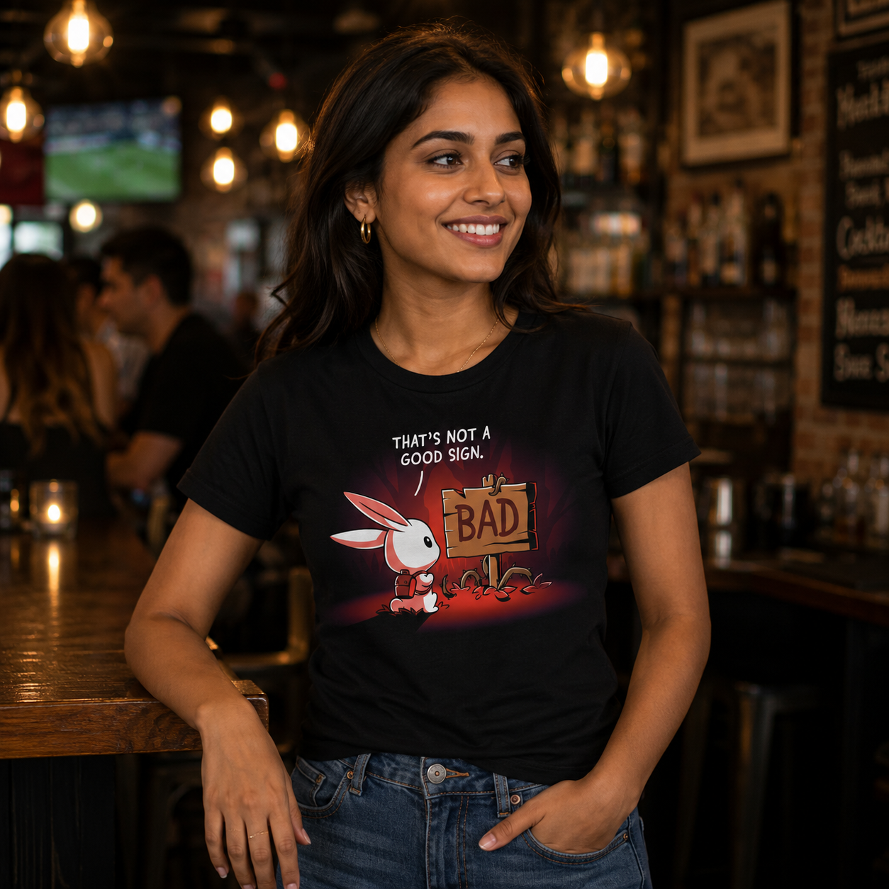 Premium Cotton T-shirt_TeeTurtle That's Not a Good Sign black t-shirt featuring an adventurous bunny looking at a wooden sign with the word "bad" on it.