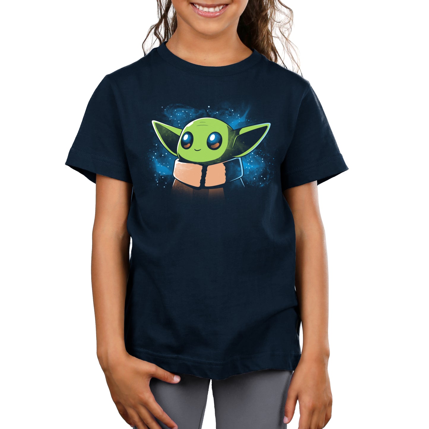 A girl wearing an officially licensed Star Wars T-shirt with The Child in Space (baby Yoda) on it.
