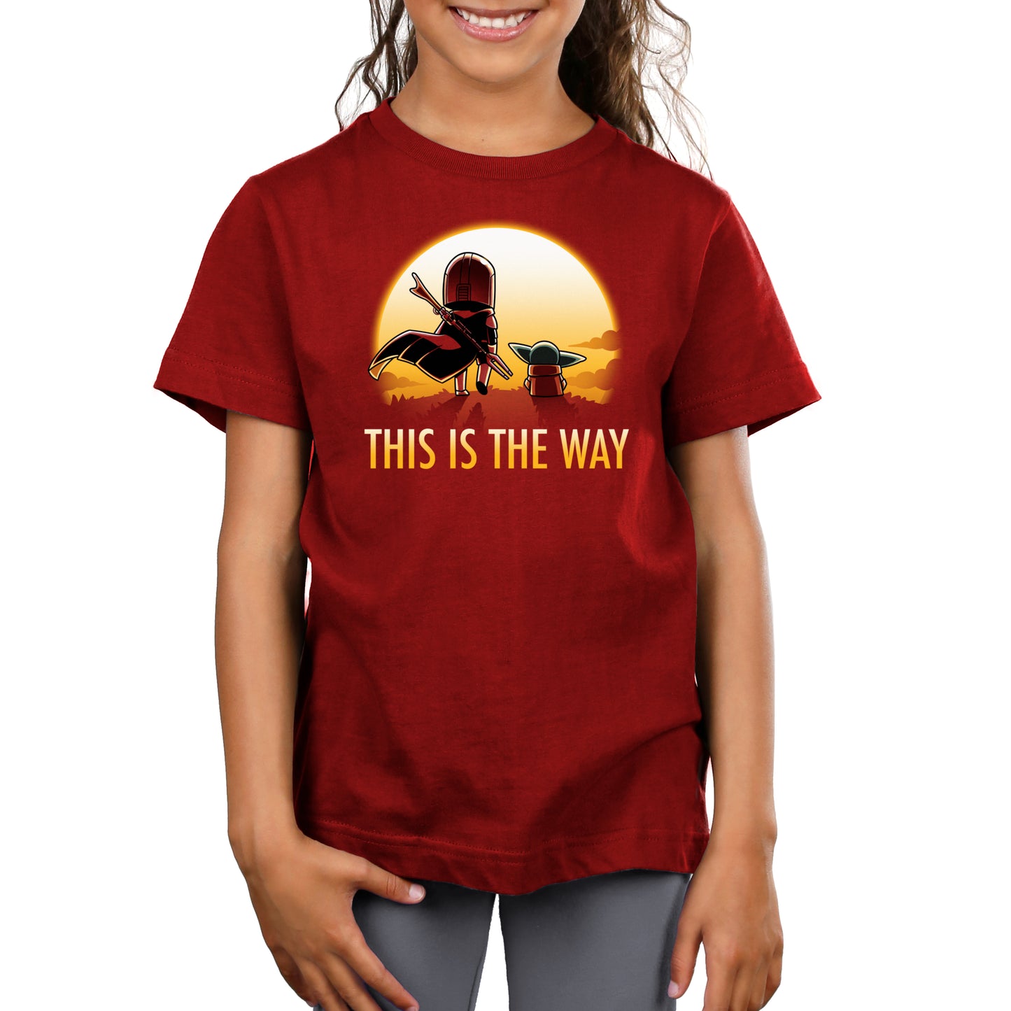 A girl wearing an officially licensed Star Wars Mandalorian-themed t-shirt, named "This is the Way (Sunset)".