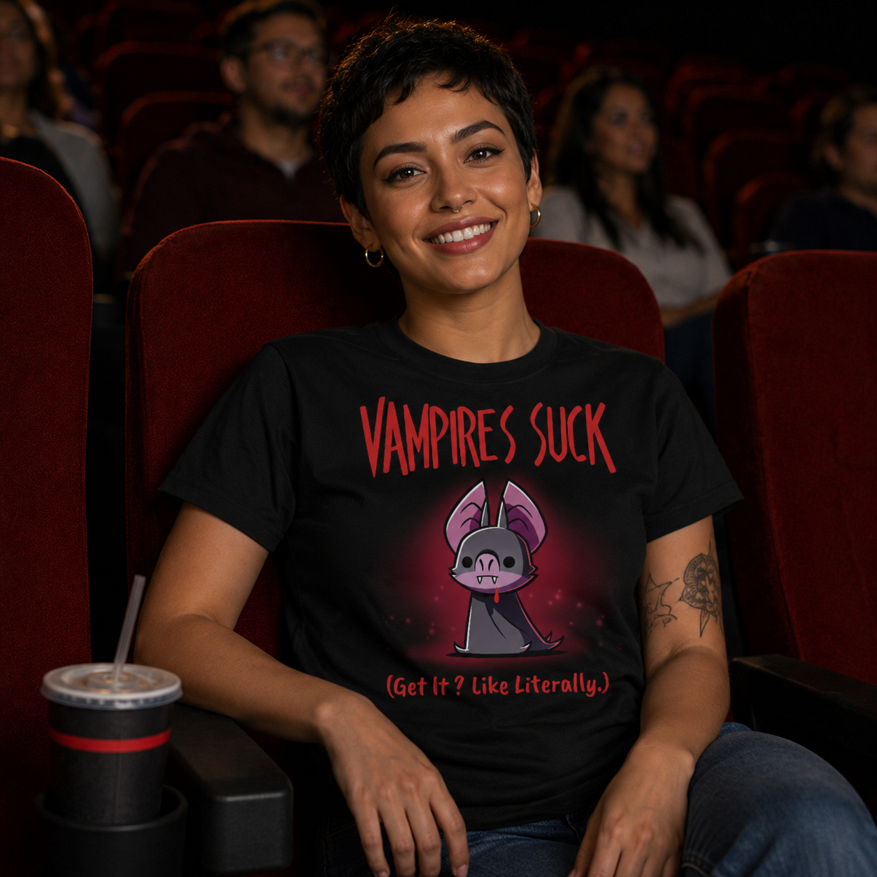 Women's Premium T-shirt_TeeTurtle black Vampires Suck Women's Premium T-shirt featuring a cute purple vampire bat with tiny fangs and a dark cape beneath the text "Vampires Suck" and the phrase "(Get It? Like Literally.)."
