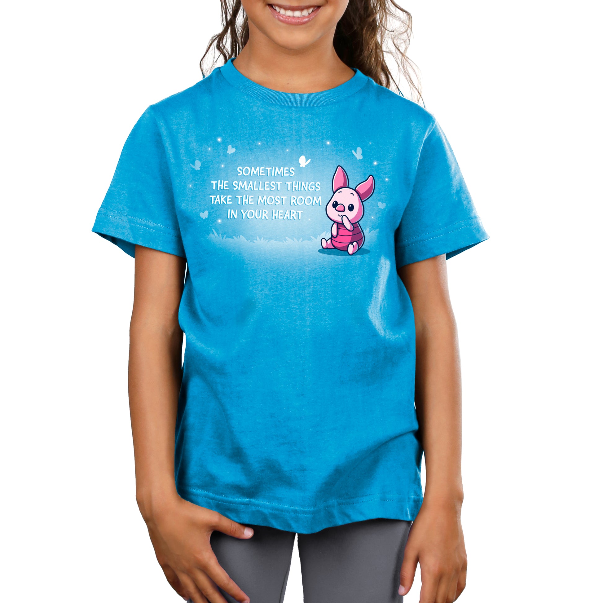 A girl wearing a Disney T-shirt named "Sometimes the Smallest Things Take Up the Most Room in Your Heart".