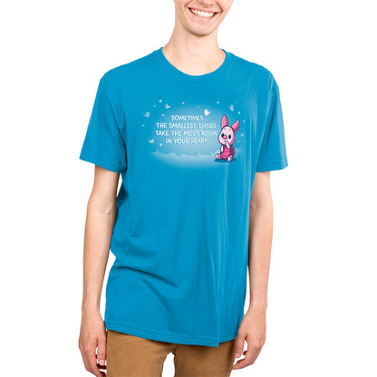 A young man wearing a blue Disney t-shirt with "Sometimes the Smallest Things Take Up the Most Room in Your Heart" and Piglet on it.