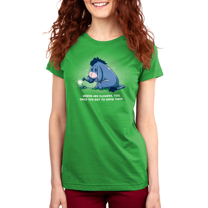 A woman wearing a Disney "Weeds Are Flowers Too" green t-shirt.