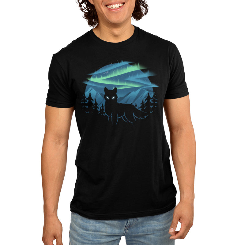 A man wearing a black t-shirt depicting the Wild Aurora borealis by TeeTurtle.