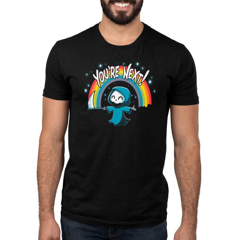 A man wearing a black t-shirt with a cartoon character and a rainbow displaying his TeeTurtle You're Next! original design.
