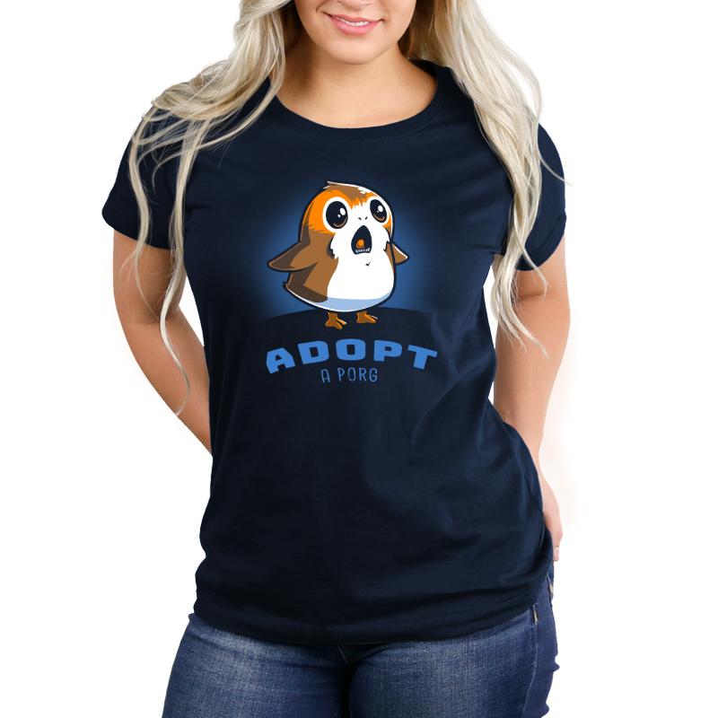 A navy blue women's T-shirt officially licensed with the phrase "Adopt me" featuring the Adopt a Porg brand from Star Wars.