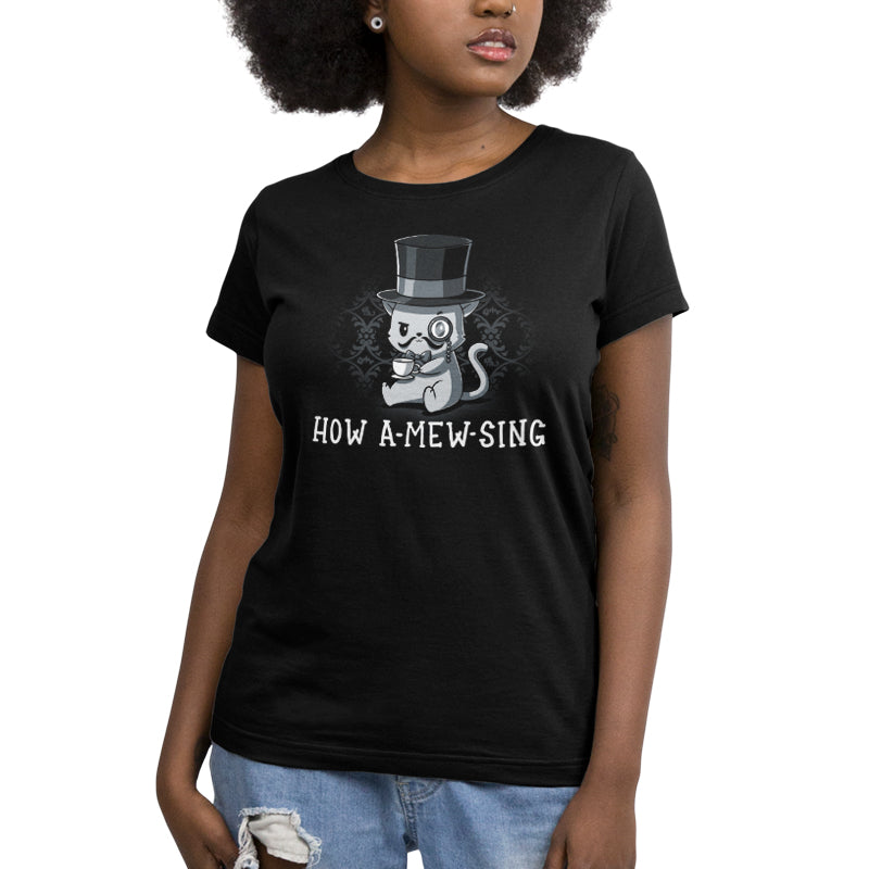 A woman wearing a TeeTurtle "How A-mew-sing" black t-shirt with a cat in a top hat and a British accent.