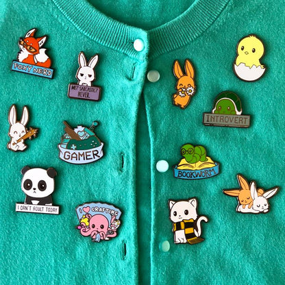A cardigan adorned with Savage Bunny Pins by TeeTurtle.