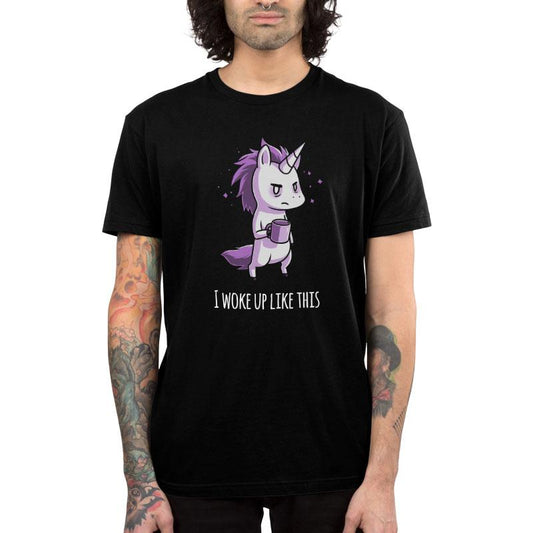 Person wearing a super soft ringspun cotton black monsterdigital T-shirt featuring a grumpy Morning Unicorn holding a coffee cup with the text 