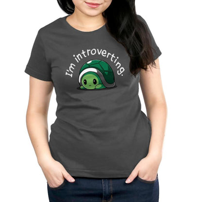 A woman wearing a gray T-shirt that says "I'm Introverting" from TeeTurtle.