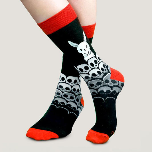 A woman wearing TeeTurtle's Killer Bunny Socks with skulls for comfort.