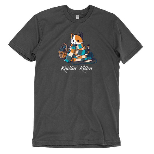 Premium Cotton T-shirt_TeeTurtle Knittin' Kitten charcoal gray t-shirt featuring a calico cat knitting a long scarf that’s wrapped around it with a basket of yarn next to it.