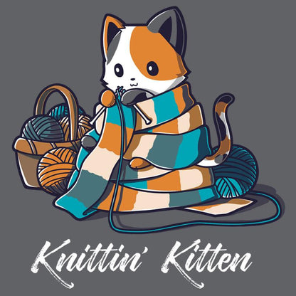 Premium Cotton T-shirt_TeeTurtle Knittin' Kitten charcoal gray t-shirt featuring a calico cat knitting a long scarf that’s wrapped around it with a basket of yarn next to it.