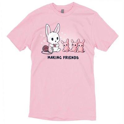 Premium Cotton T-shirt_Teeturtle light pink Making Friends apparel featuring a white bunny knitting 3 bunny friends out pink of yarn, caption reads, "Making Friends'.