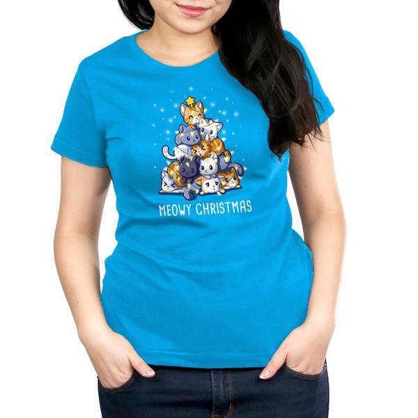 A woman wearing a cobalt blue Meowy Christmas t-shirt from TeeTurtle with cats on it.