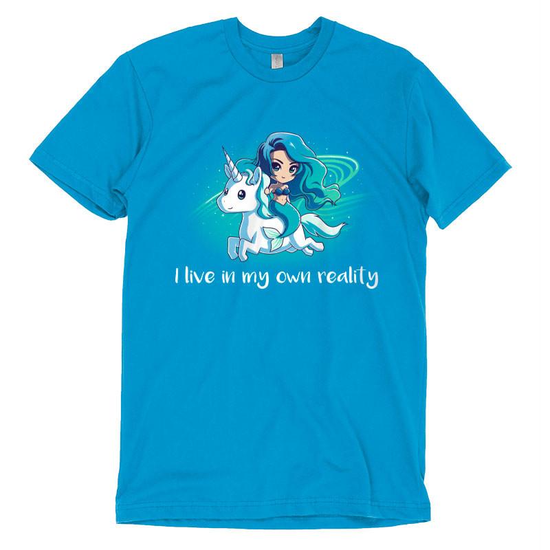 Cobalt blue T-shirt featuring an illustration of a girl riding a unicorn with the text "I live in my own reality" printed below, My Reality by monsterdigital.