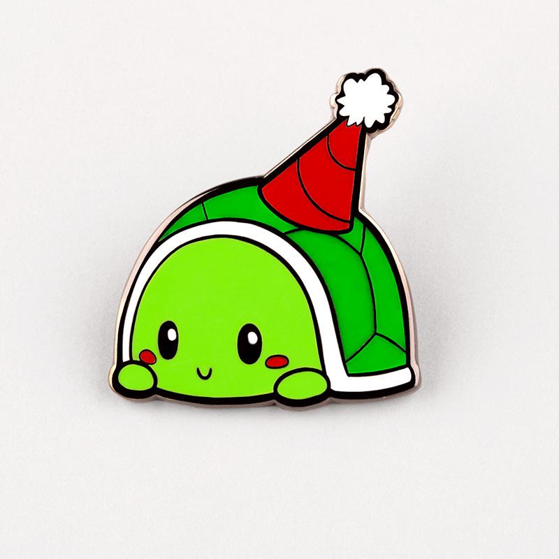 A green Party Turtle Pin wearing a santa hat at a pizza party. Brand Name: TeeTurtle