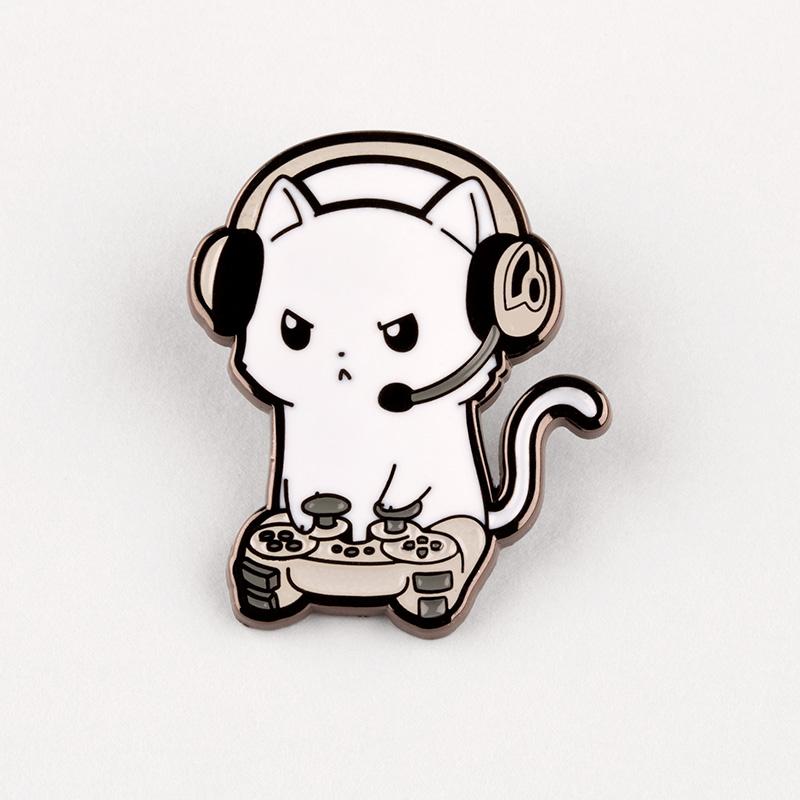 A white cat wearing Pew Pew Kitty Pins and headphones is playing a video game by TeeTurtle.