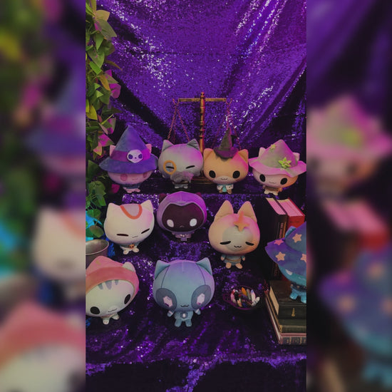 Mystic Moon Cloudheads Bundle - Bundle features all 10 cat witch character Cloudheads from our game Mystic Moon. This image shows othe Cloudheads in front of a purple background with old books, a vintage scale and container of crystals visible. 