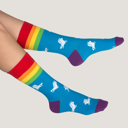 A woman wearing a pair of TeeTurtle Rainbow Unicorn Socks.