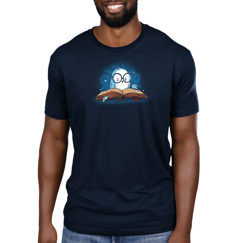 A man wearing a navy blue Reading is Magical T-shirt with an image of a man reading a book. (Brand Name: TeeTurtle)