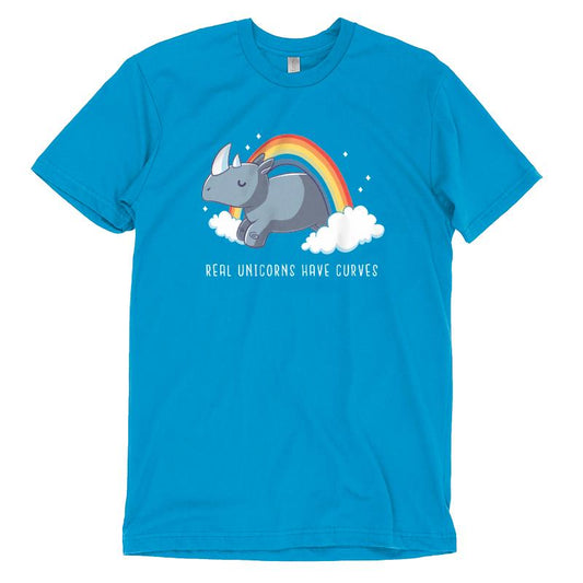 Cobalt blue t-shirt featuring a cartoon rhino with a horn, lying on clouds with a rainbow above it and the text, 