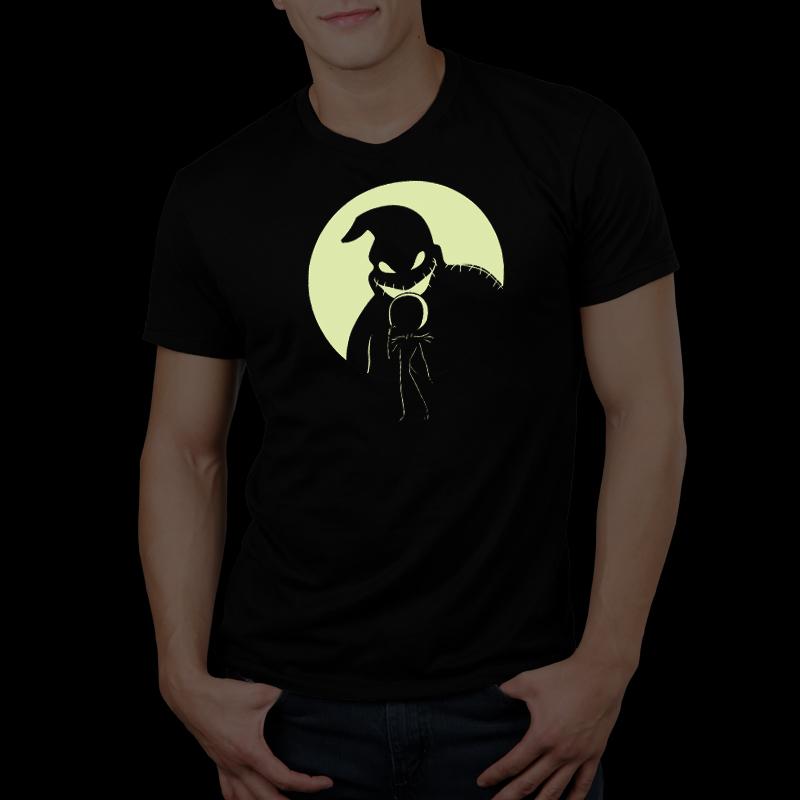 A man wearing a black t-shirt featuring the "Shadow on the Moon" glow in the dark skeleton from Disney's Nightmare Before Christmas.