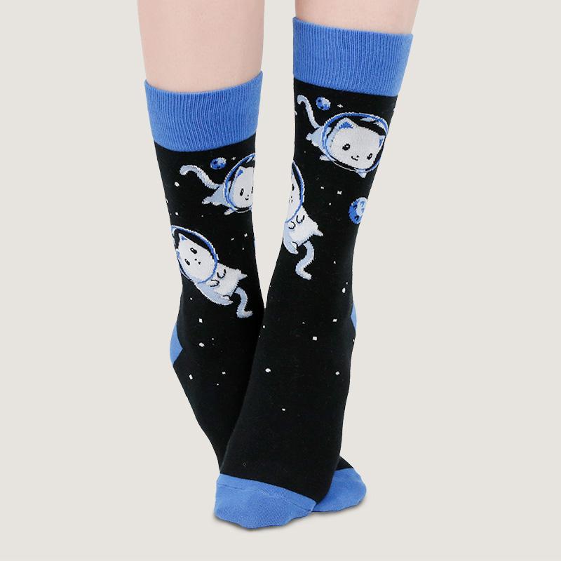 A woman wearing a pair of TeeTurtle Space Cat socks in Houston.