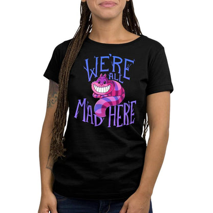 A woman wearing an Officially Licensed Disney t-shirt featuring the Cheshire Cat called "We're All Mad Here".